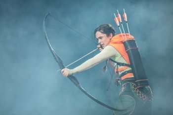 Mia Carragher as Katniss Everdeen in The Hunger Games on Stage. Photo by Johan Persson. ®™ © 2025 Lionsgate Entertainment Inc. All Rights Reserved.